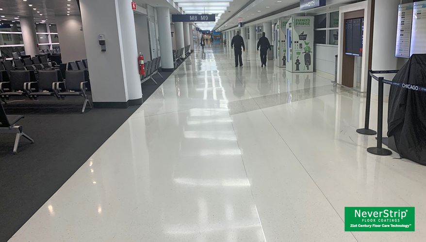 High-traffic airport corridor with resilient flooring maintained using a non-stripping floor protection system.