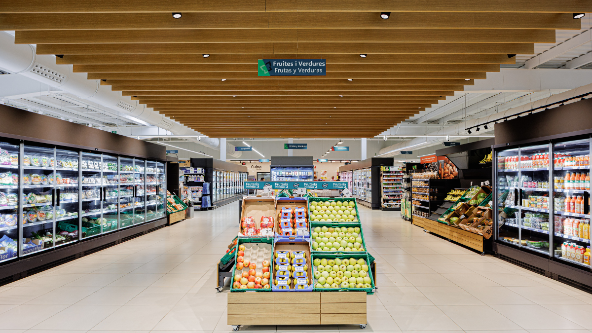 Grocery store aisle with resilient flooring in a high-traffic retail environment