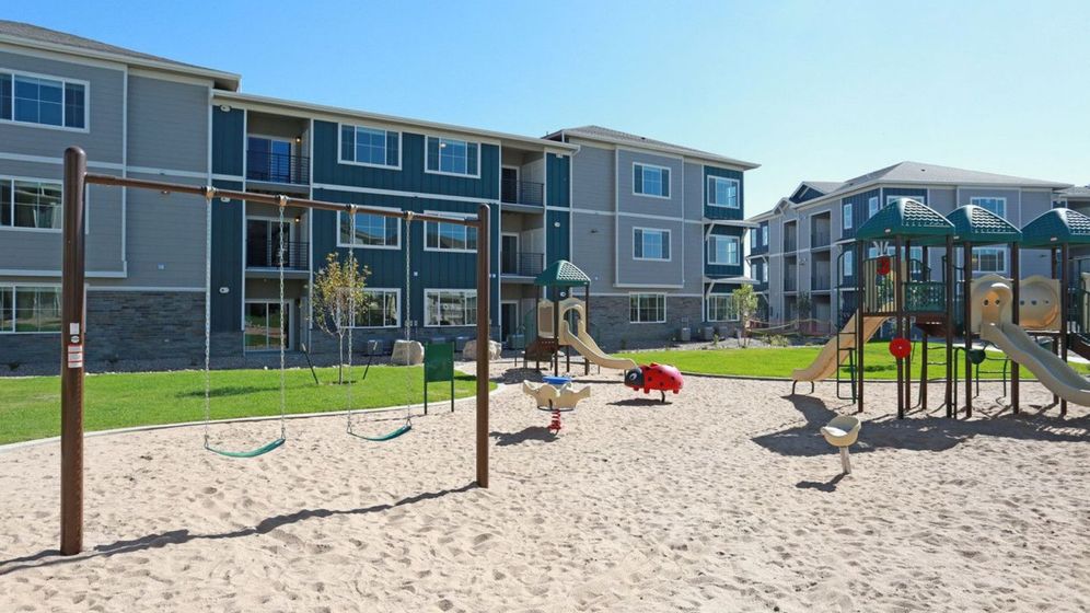 A park with apartment complexes in the background A park with apartment complexes in the background