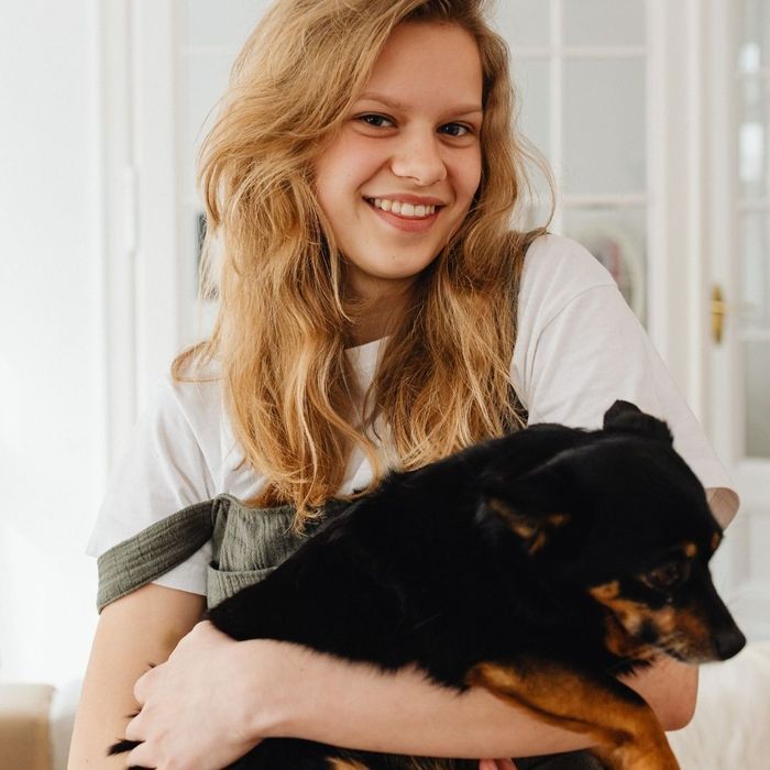 girl holding her dog