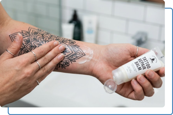 putting aftercare lotion on a new tattoo