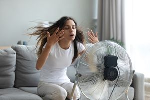 woman in front of fan woman in front of fan