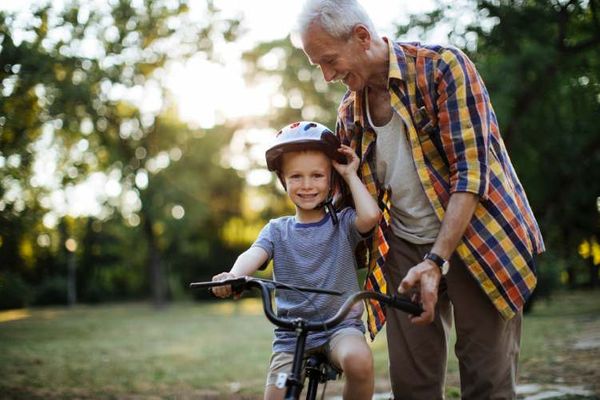 grandpa teaching grandson to bike ride