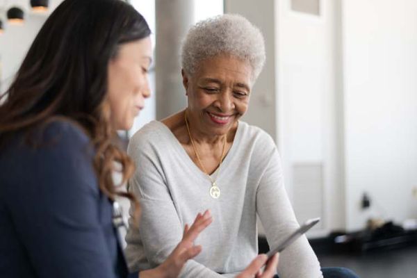 woman speaking with elderly woman