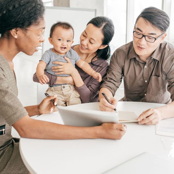 family looking at life insurance policies with agent