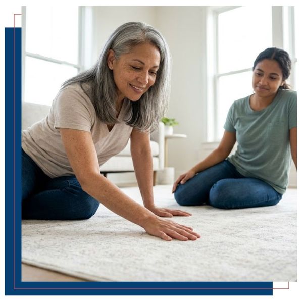 A woman happily touching a pristine area rug.