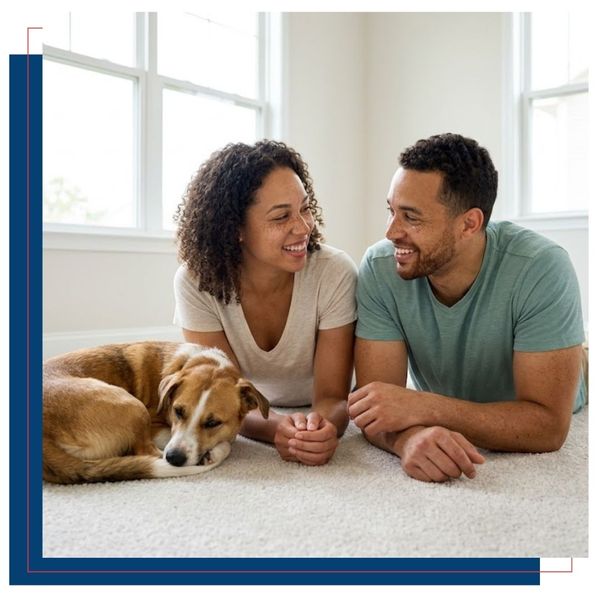 A couple and their dog on a freshly cleaned carpet.