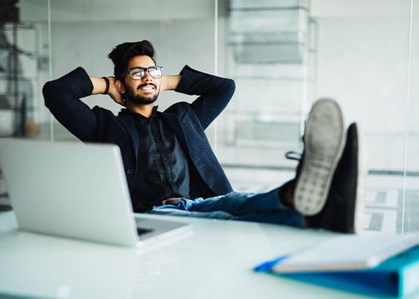 young man with feet up on desk