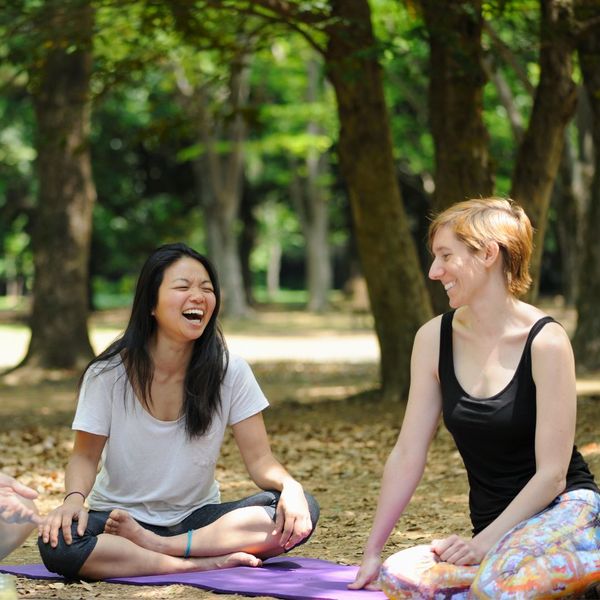 smiling friends doing yoga