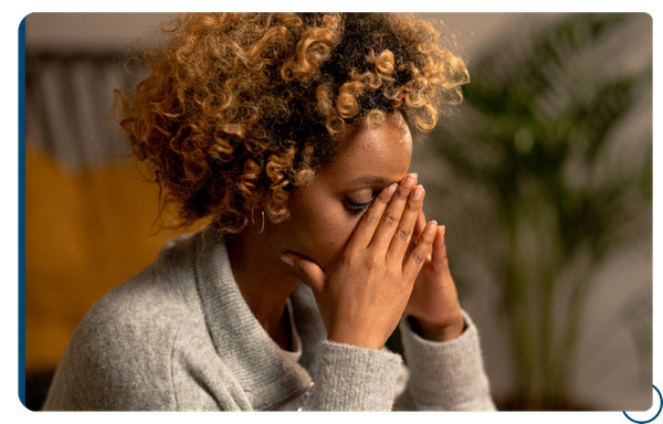 stressed-out young woman pinching bridge of nose