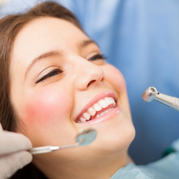Women smiling while getting dental work