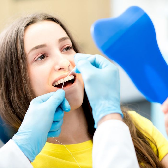 patient getting flossing service at dentist