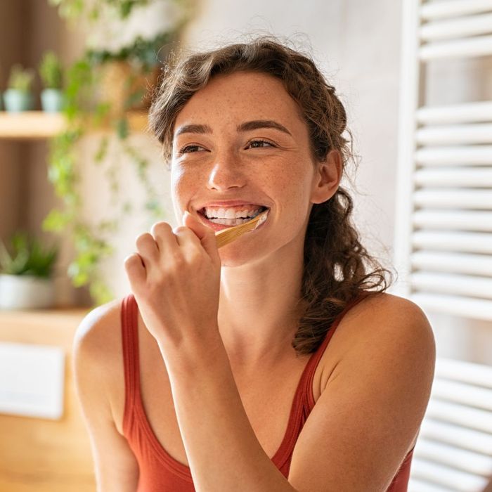 smiling person brushing teeth