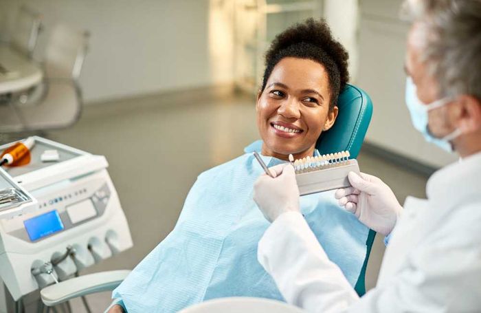 dentist showing veneers to patient