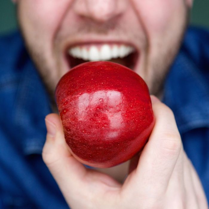 a person biting into an apple