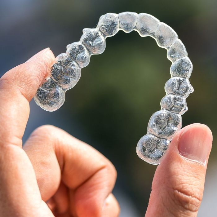 person holding invisalign aligner