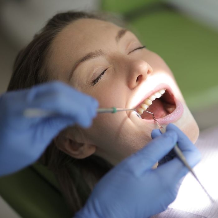 a woman having her teeth inspected