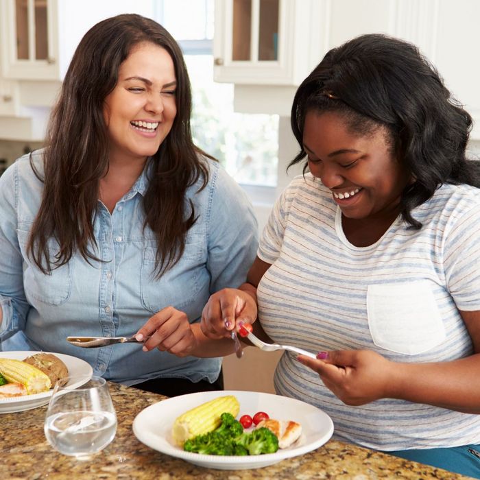 two women eating healthy meals