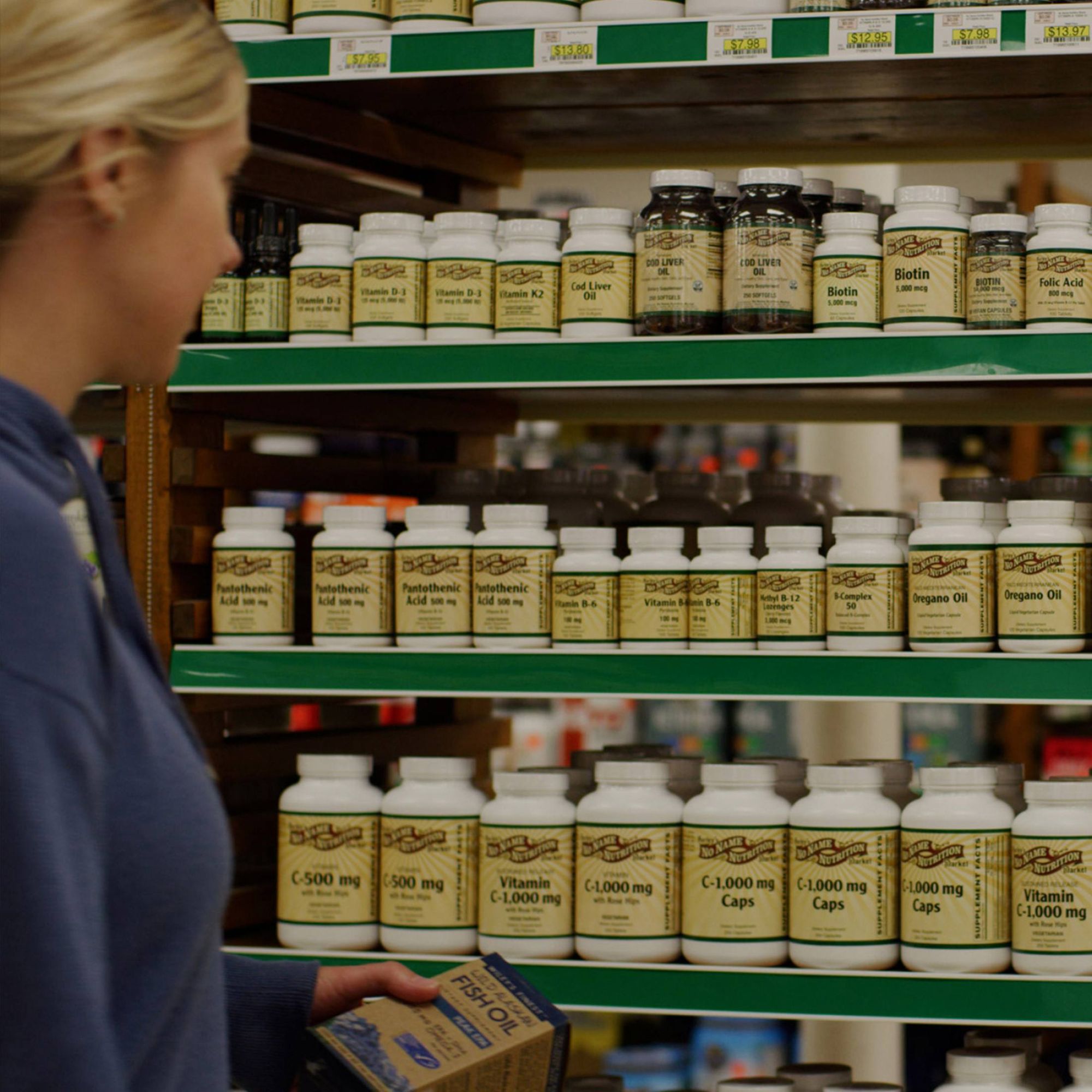 Image of a woman looking at vitamins on a shelf