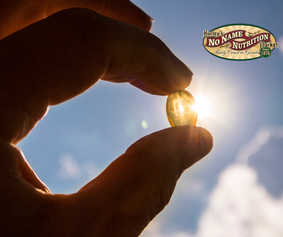 Image of a man holding a vitamin to the sun