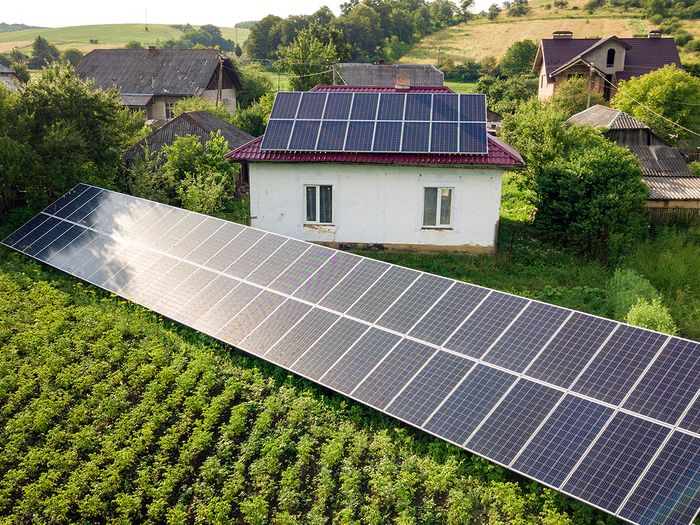 A home with solar ground mounts on the property.