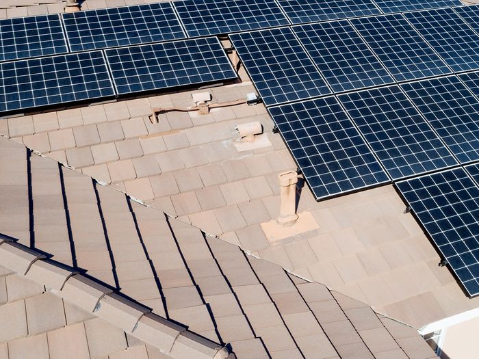 Rooftop solar panels installed on a large home.