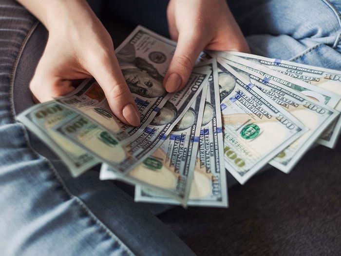 person holding stack of cash