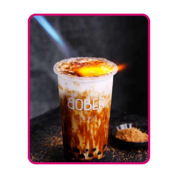 Bober Tea’s Brown Sugar Creme Brulee Latte being torch-fired to create a caramelized sugar crust. The drink features beautiful brown sugar streaks (tiger stripes), fresh milk, and chewy boba pearls at the bottom.
