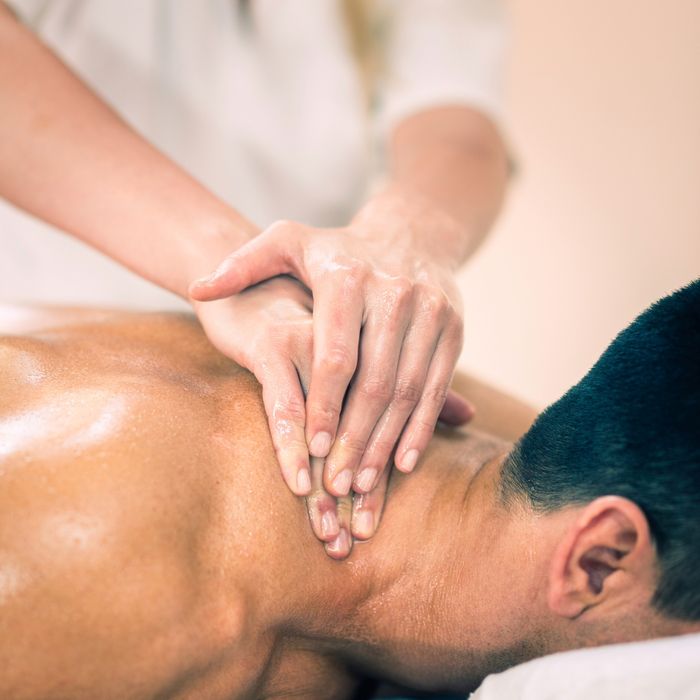 woman massaging man's neck