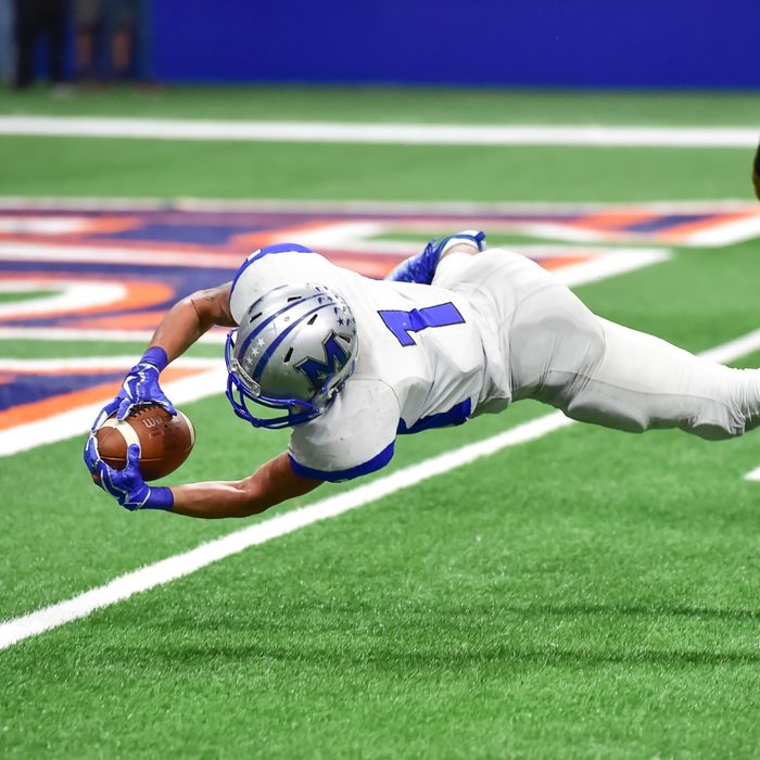 football player diving for ball
