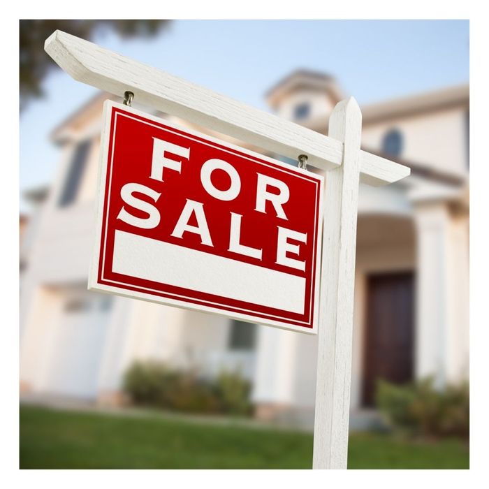 for sale sign in front of a home