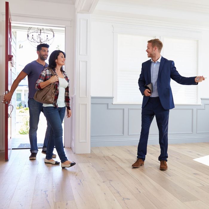 realtor showing a couple a home