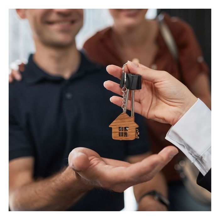 handing keys to the new homeowner