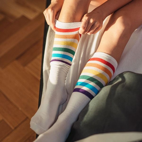 a woman putting on medical compression stockings, essential for post-sclerotherapy recovery for patients in Greenwood Village and Littleton