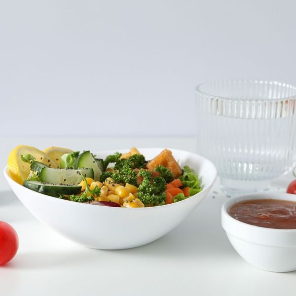 A glass of water and a healthy snack on a stone counter, representing pre-appointment hydration for sclerotherapy in Denver