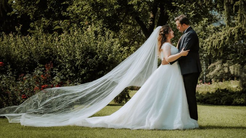bride and groom standing outside