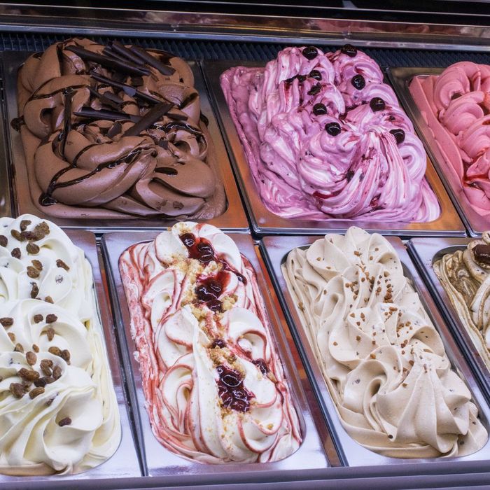 Multiple flavors of gelato in a display case. 