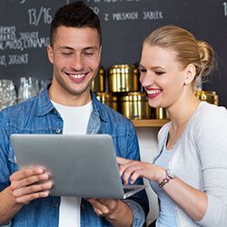 Two small business owners looking at their laptop