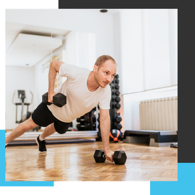 man doing push-up exercise with dumbbell