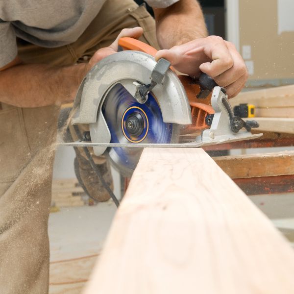 someone using a circular saw on a piece of wood