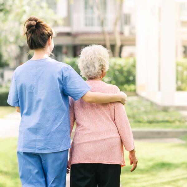 elderly woman with caretaker