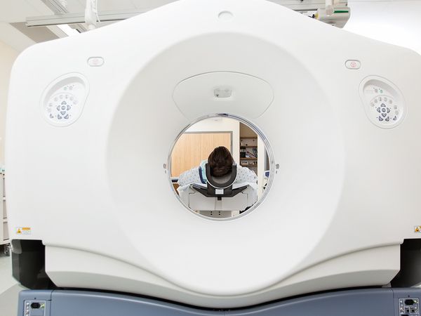 An image of a person going into a CT scan.