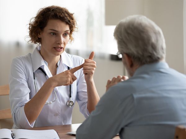 Doctor explaining different factors that play into the effectiveness of a patient's medication Doctor explaining different factors that play into the effectiveness of a patient's medication