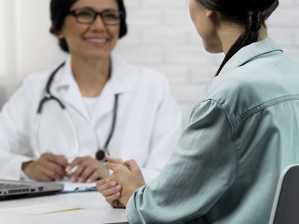 Doctor smiling at a patient Doctor smiling at a patient
