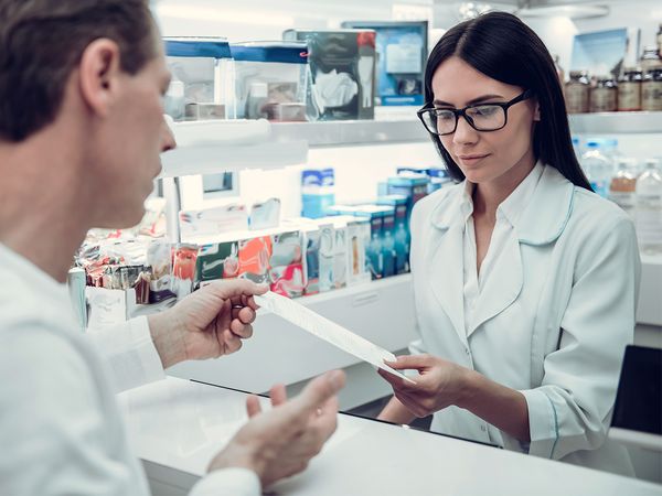 Man filling a prescription at a pharmacy Man filling a prescription at a pharmacy