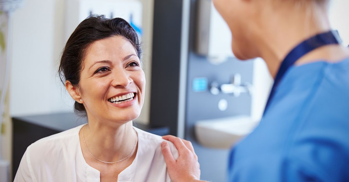 doctor placing hand on patient's shoulder