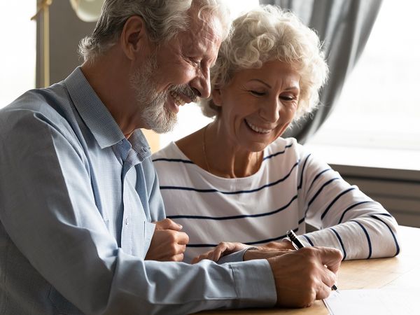 Elderly couple happy because they are saving money on healthcare