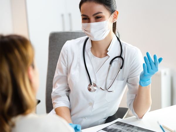 doctor smiling and discussing options for her patient doctor smiling and discussing options for her patient