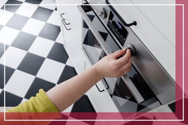person turning dial on oven