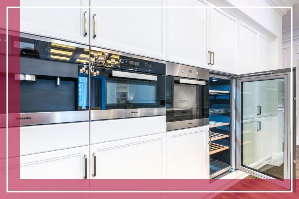 A built-in wall of modern, luxury kitchen appliances, including a Miele oven and a wine refrigerator. A built-in wall of modern, luxury kitchen appliances, including a Miele oven and a wine refrigerator.